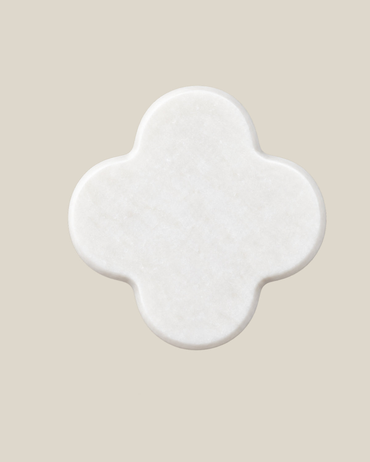 ALHAMBRA Door Knob by ATOMS in White, front view of the four-lobed natural stone face.