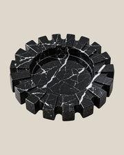 Aston Ash Tray in Spanish Black Marble, three-quarter view showing the carved notched rim and recessed centre.