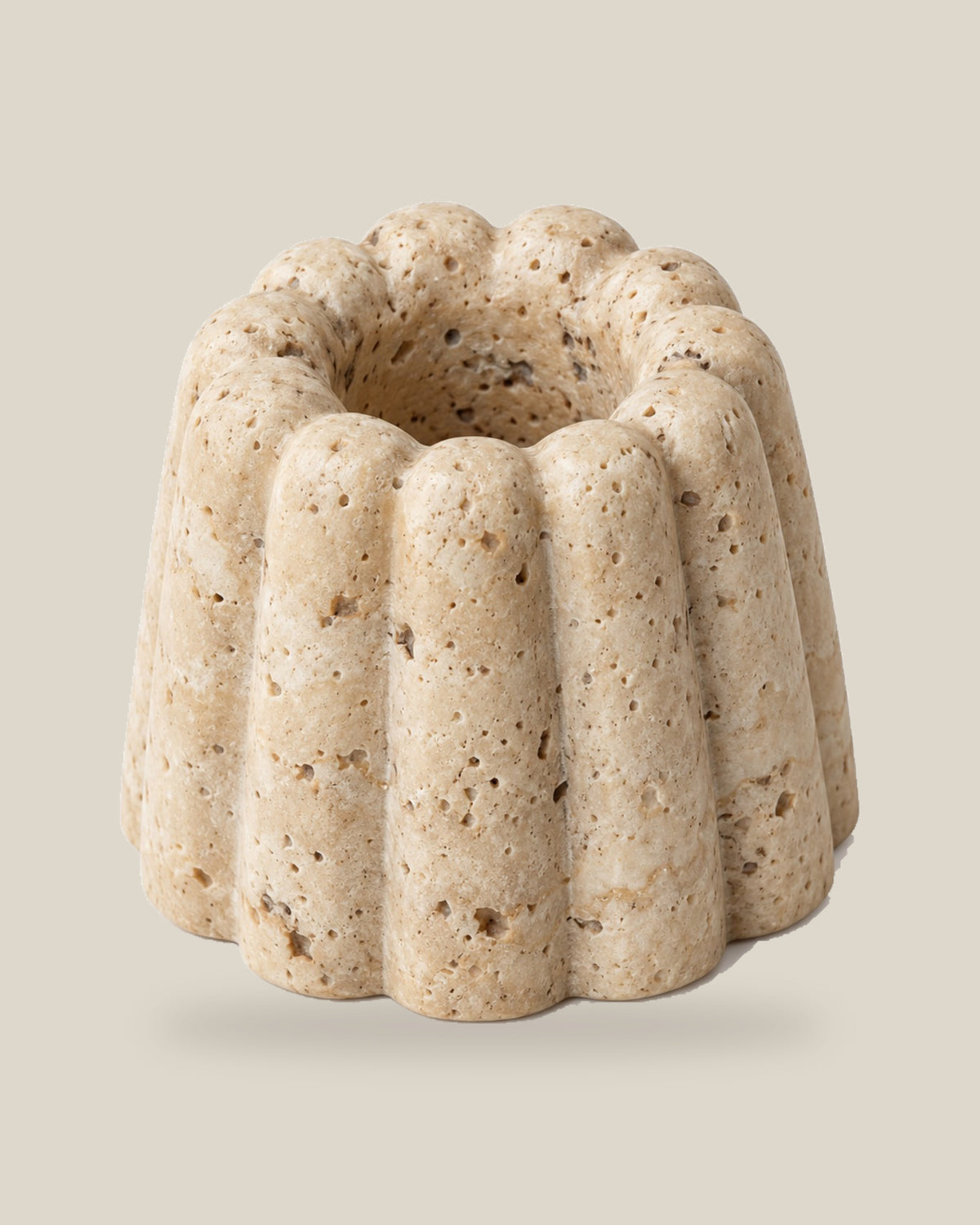 ATOMS Cupcake Essence Holder in Travertine Beige, elevated view showing the recessed centre, on BONE background.