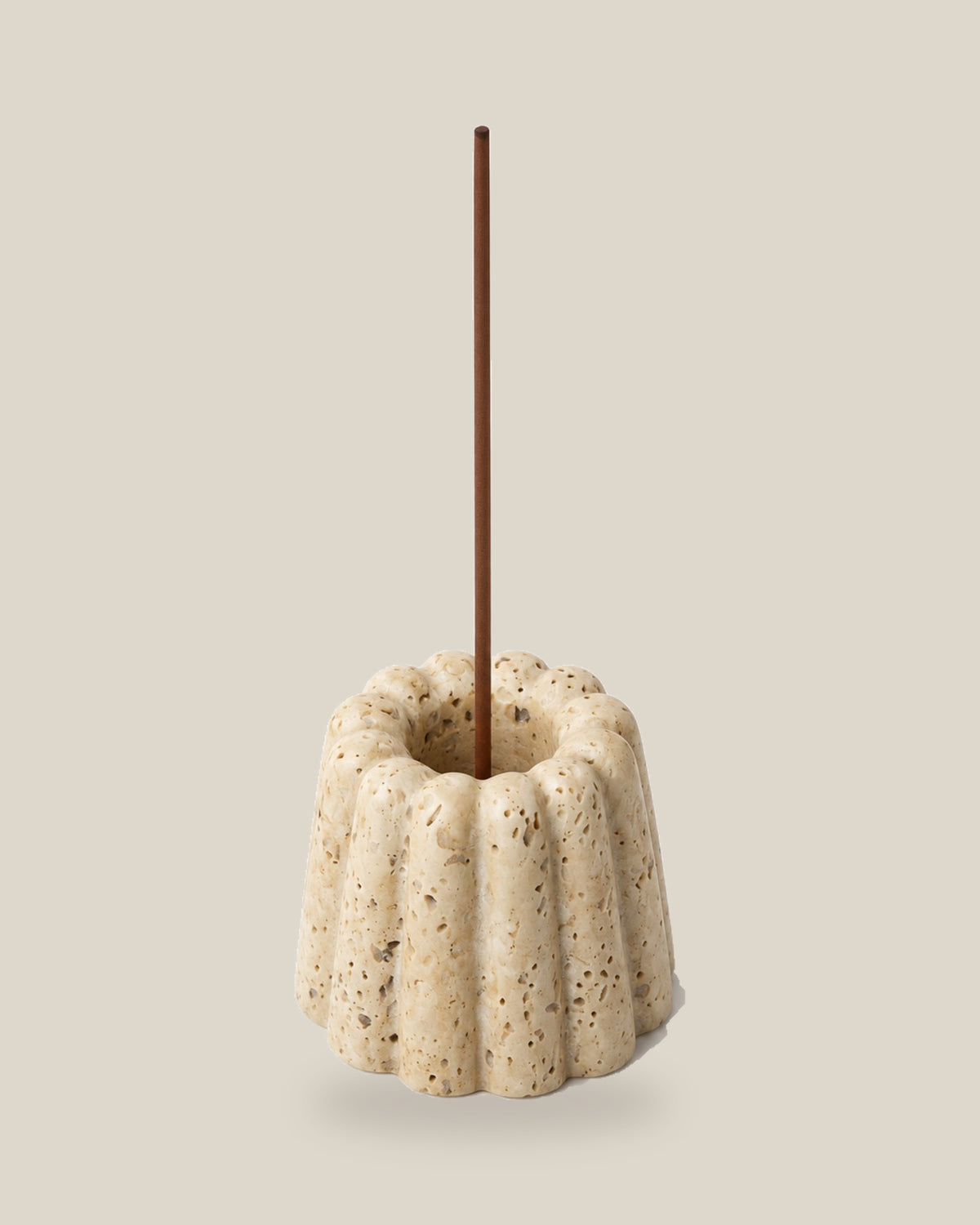 ATOMS Cupcake Essence Holder in Travertine Beige, shown with an incense stick; stick not included, on BONE background.