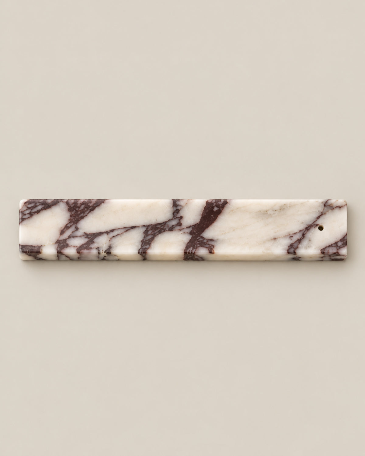 Overhead view of LINEA Incense Holder in Calacatta Viola marble.