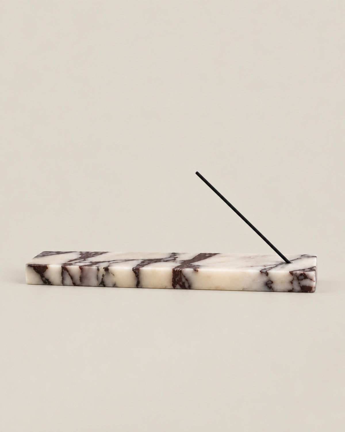 Low front view of LINEA Incense Holder in Calacatta Viola marble.