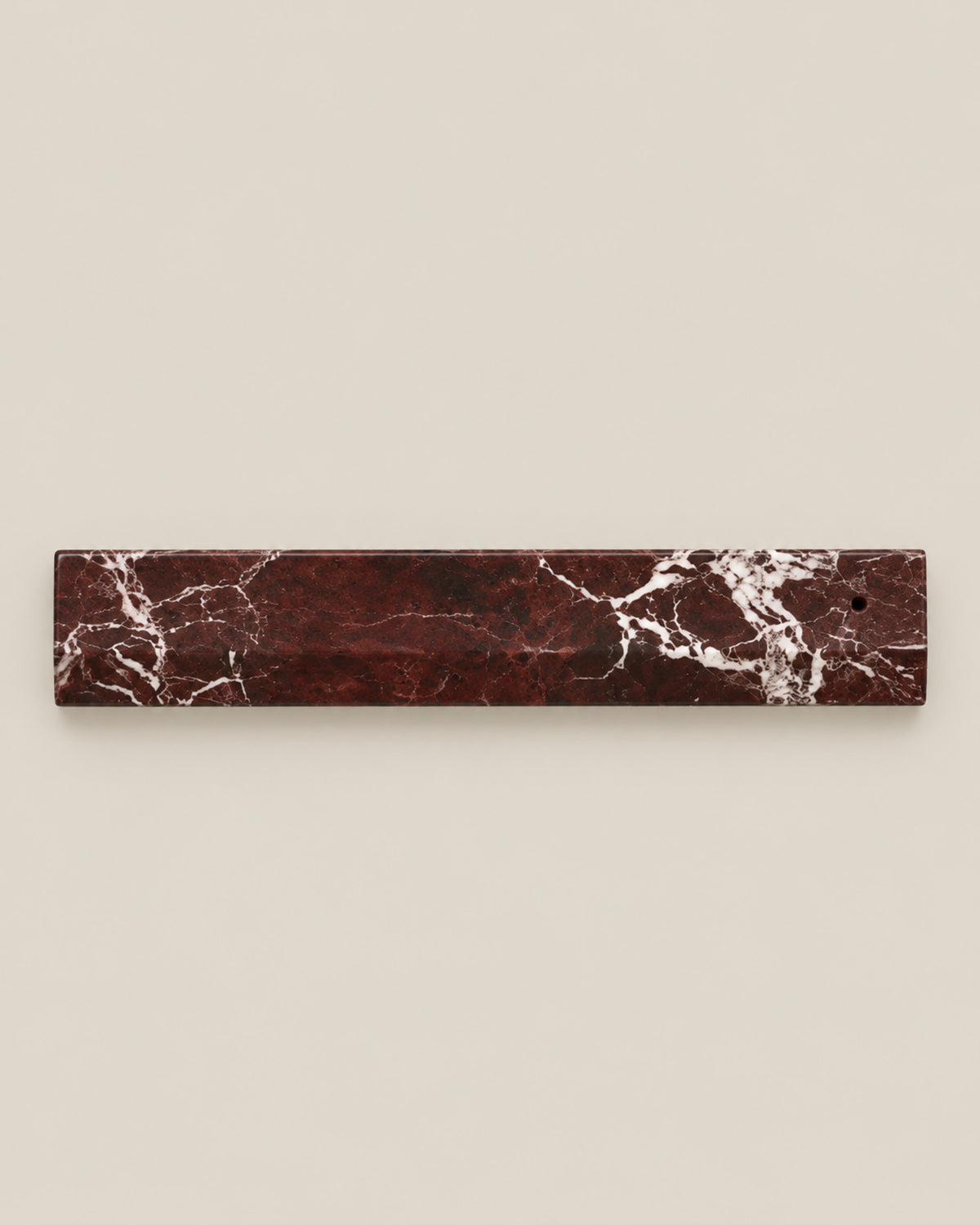 Overhead view of LINEA Incense Holder in Rosso Levante marble.