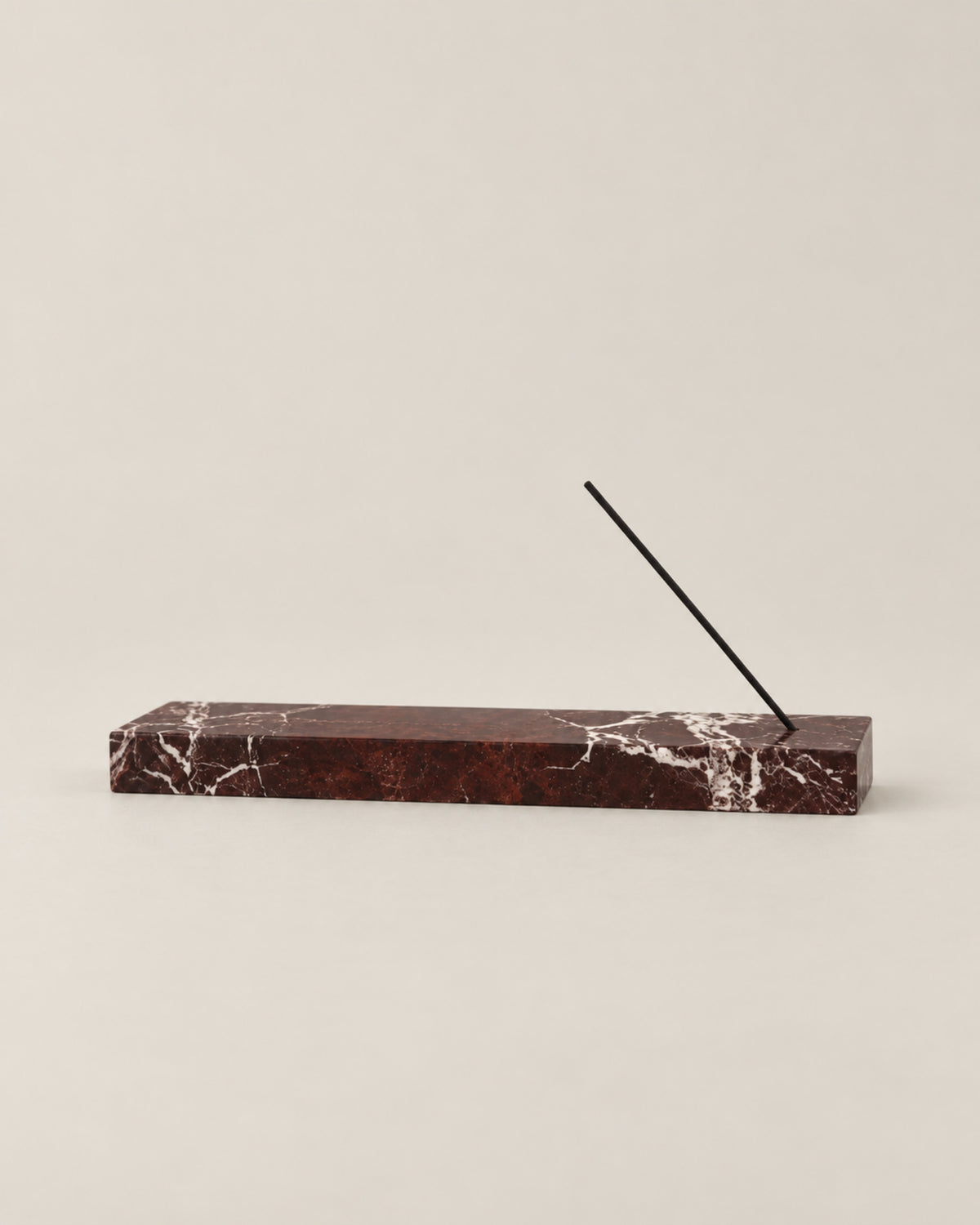 Low front view of LINEA Incense Holder in Rosso Levante marble.