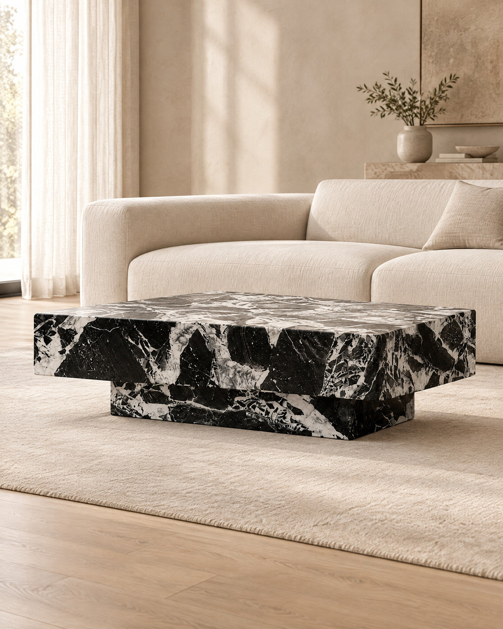 BUTTER coffee table by CARVINGS in Grand Antique Black Marble, in a styled living room, left view.