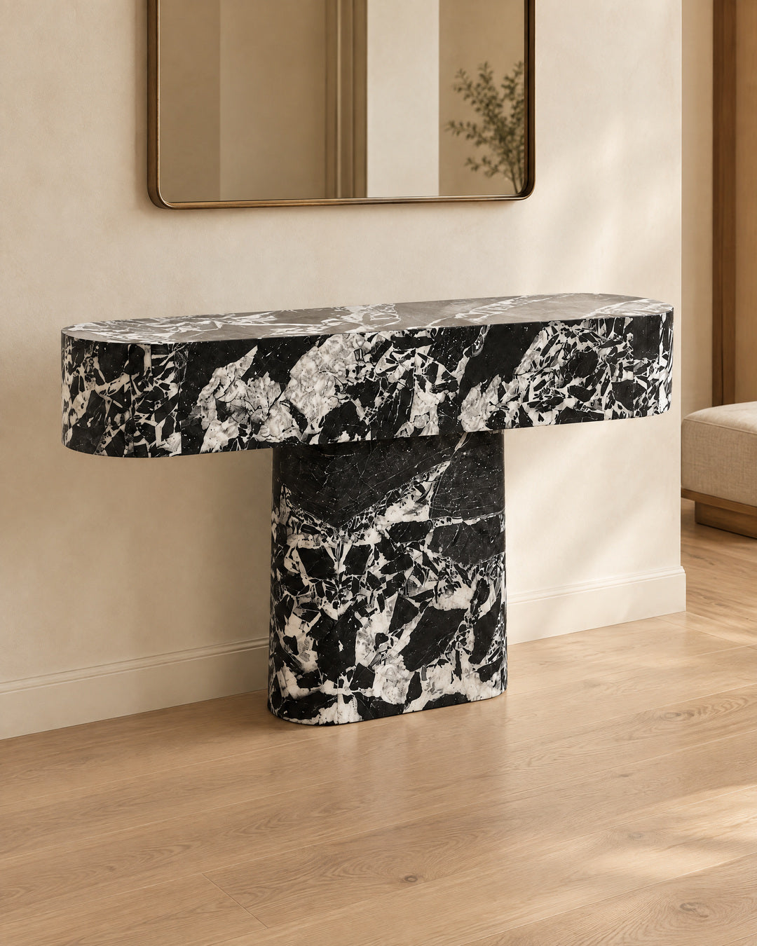 BUTTER console table by CARVINGS in Grand Antique Black Marble, in a styled interior, left view.