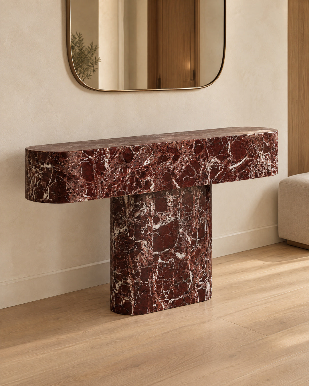 BUTTER console table by CARVINGS in Rosso Levante Marble, in a styled interior, right view.