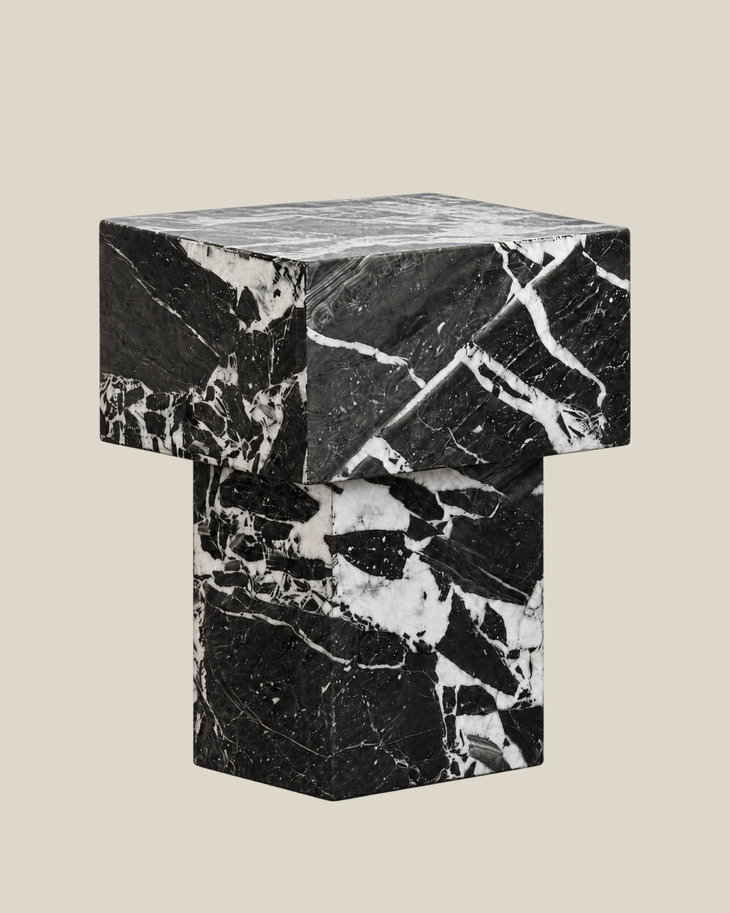 BUTTER side table by CARVINGS in Grand Antique Black Marble, on a BONE background, left view.