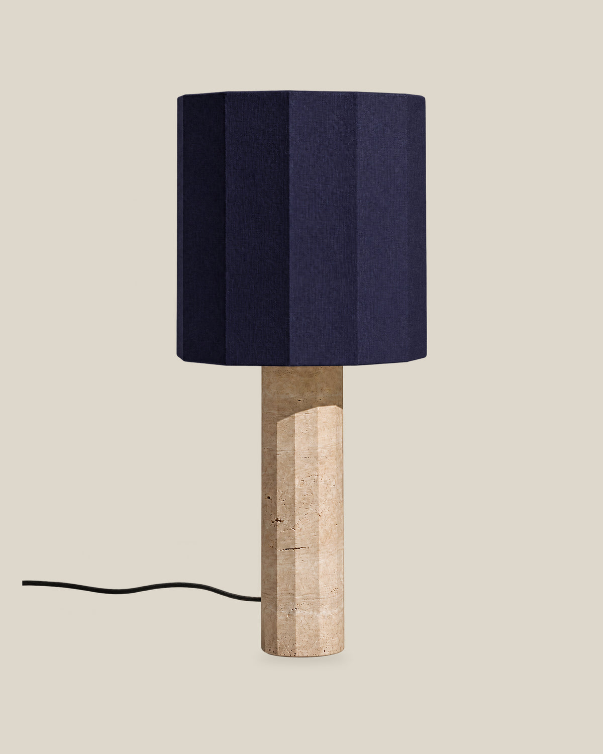 Roma Table Lamp, Large Faceted, Travertine Beige + Dark Blue, on a bone background.
