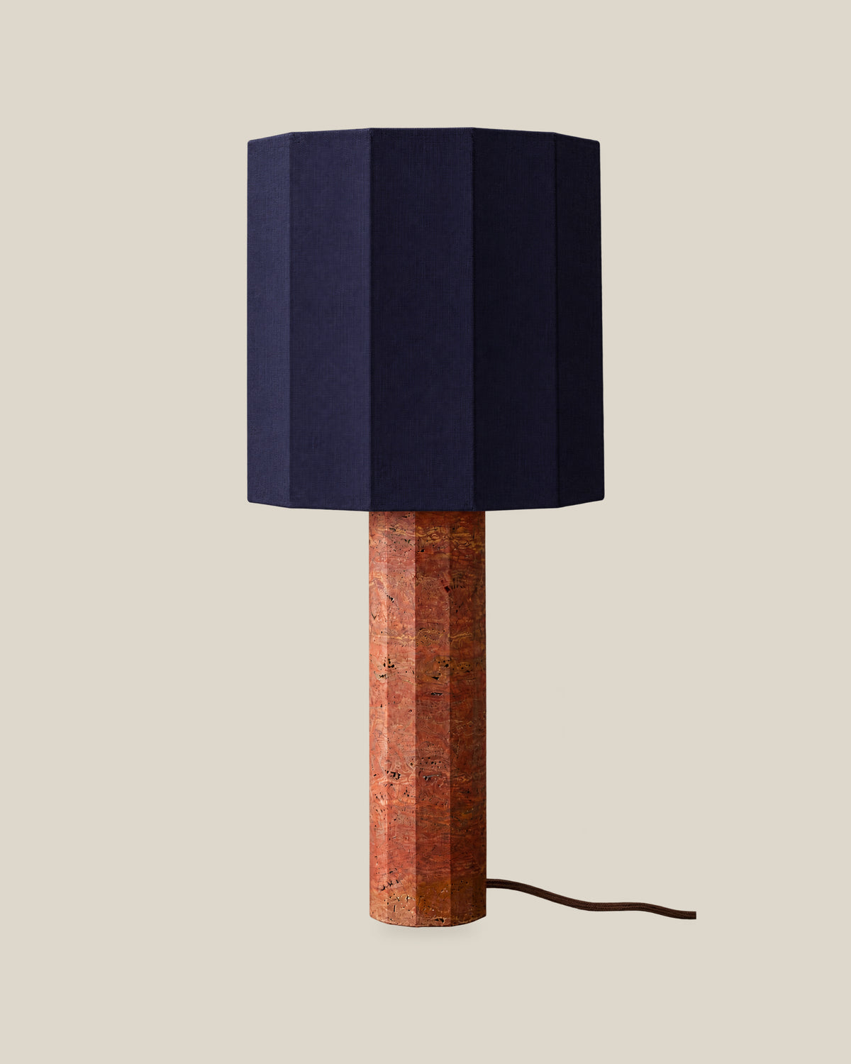 Roma Table Lamp, Large Faceted, Travertine Red + Dark Blue, on a bone background.