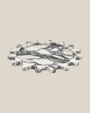 Sun Orbit Tray in Arabescato natural marble, low front view, rounded sun rays and recessed circular centre.