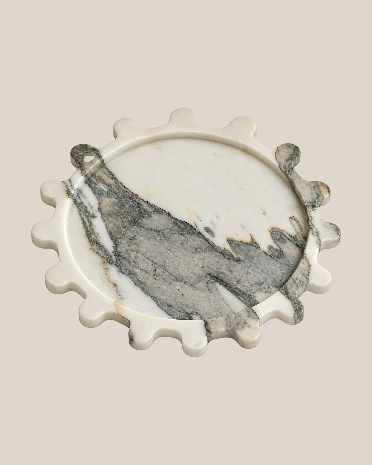 Sun Orbit Tray in Limited Edition Calacatta Borghini natural marble, three-quarter view, rounded sun rays and recessed circular centre.