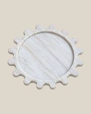 Sun Orbit Tray in Calacatta Gold natural marble, three-quarter view, rounded sun rays and recessed circular centre.